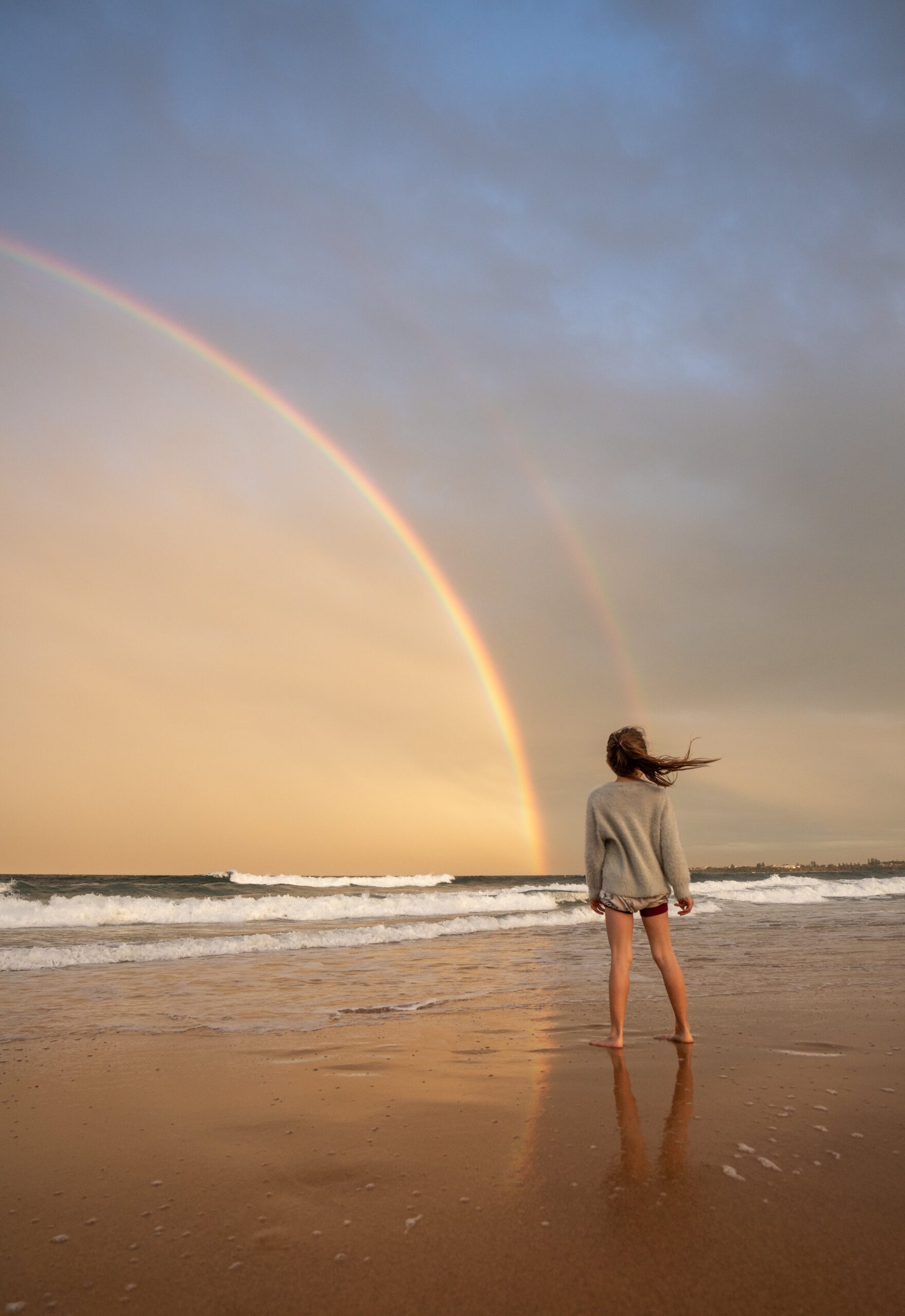 Girl on Beach with a Gorgeous Rainbow